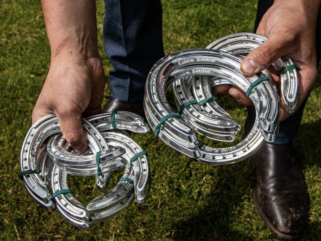 james hardy local farrier holding horse shoes of different sizes